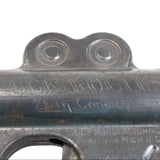 Close-up of a metal object with 'Black Powder' branding on a white background
