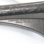 Close-up of a gun stock with engraved details and branding on a white background
