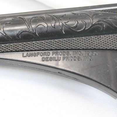 Close-up of a gun stock with engraved details and branding on a white background
