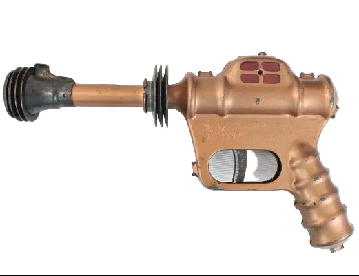 Bronze-colored gun-like object on a white background