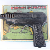 Vintage Ronson Repeater toy gun with packaging on a white background