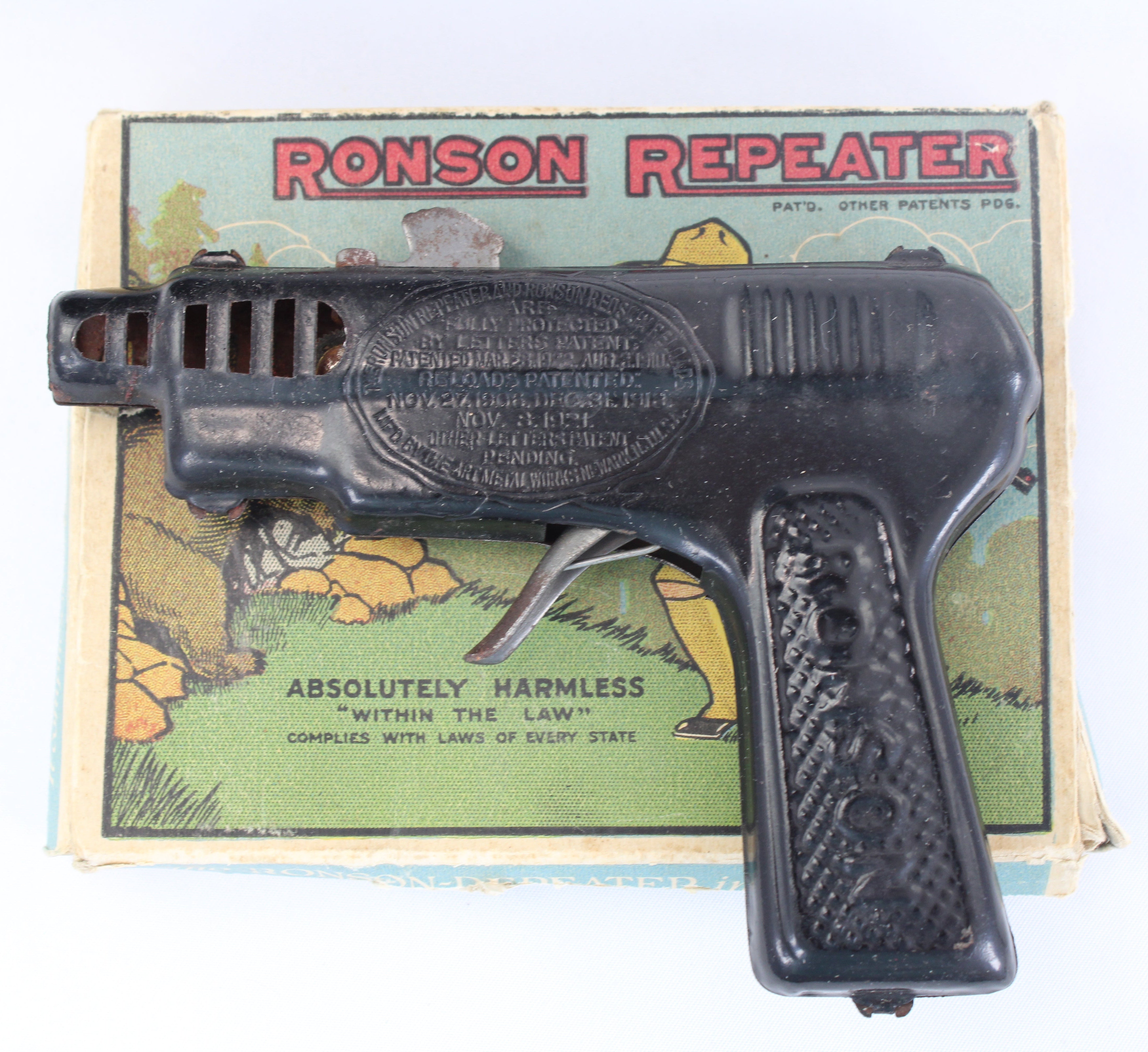 Vintage Ronson Repeater toy gun with packaging on a white background