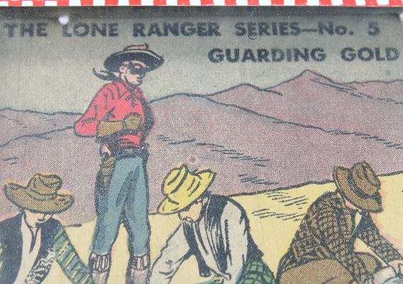Vintage illustration of a cowboy and three other figures with mountains in the background, labeled 'The Lone Ranger Series No. 5 Guarding Gold'.