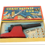 Vintage toy Coast Defense Gun in its original packaging on a white background