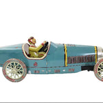 Vintage toy race car with a driver figure on a white background
