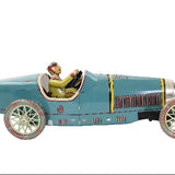 Vintage toy race car with a driver figure on a white background