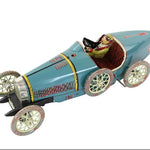 Vintage toy car with a driver figure on a white background