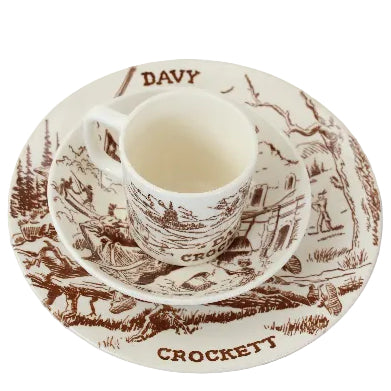 Ceramic cup and saucer set with 'Davy Crockett' design on a white background