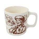 White mug with brown graphic of a person holding a rifle on a white background