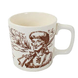 White mug with brown graphic of a person holding a rifle on a white background