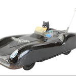 Vintage toy car with Batmobile design on a white background