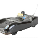 Vintage toy car with Batmobile design on a white background