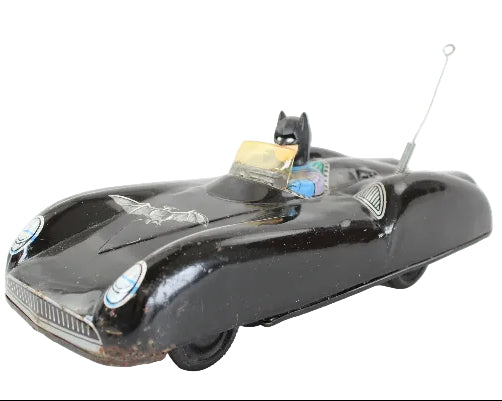 Vintage toy car with Batmobile design on a white background