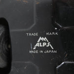 Close-up of a black product with 'Alps' branding and 'Made in Japan' text.
