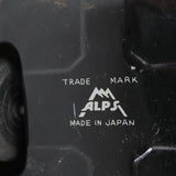 Close-up of a black product with 'Alps' branding and 'Made in Japan' text.