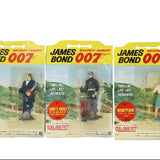 Three James Bond action figure blister packs with different characters on a white background