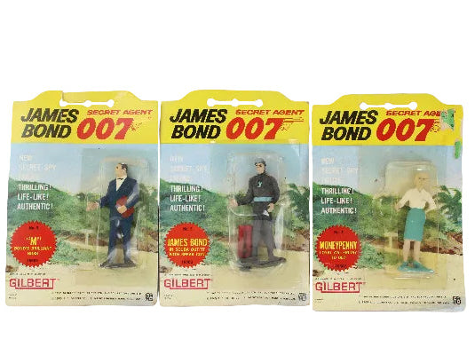 Three James Bond action figure blister packs with different characters on a white background