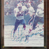 Framed sports memorabilia featuring a player in action with 'O.J. Simpson' branding.