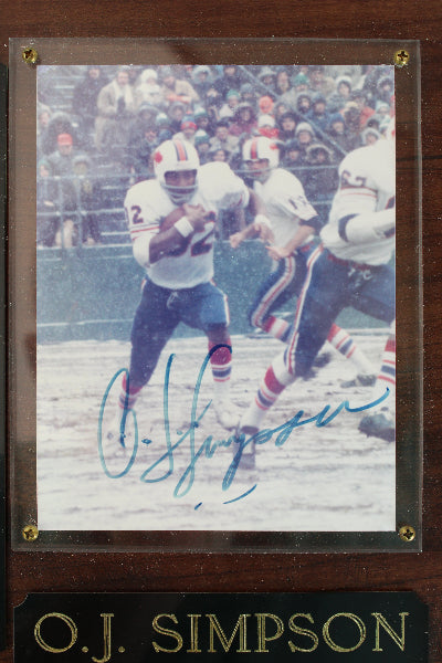 Framed sports memorabilia featuring a player in action with 'O.J. Simpson' branding.