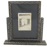 Decorative picture frame with a small photograph inside on a white background