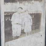 Vintage photograph of Lou Gehrig and batboy on a dark background