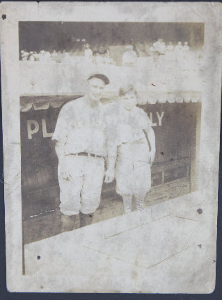 Vintage photograph of Lou Gehrig and batboy on a dark background