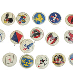 Collection of vintage buttons with various designs on a white background