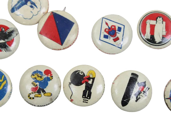 Collection of vintage buttons with various designs on a white background
