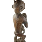 Wooden sculpture of a figure on a white background