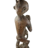 Wooden sculpture of a figure on a white background