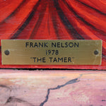 Brass nameplate with 'Frank Nelson 1978 The Tamer' on a red background