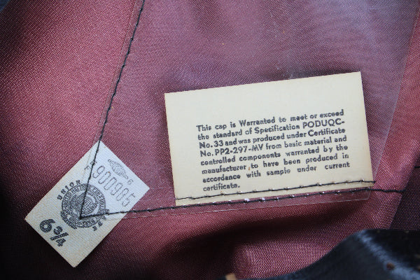Close-up of clothing labels on a maroon fabric background