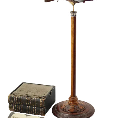 Vintage-style magnifying glass and books on a white background