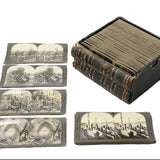 Set of vintage stereoscopic cards with a black leather case on a white background