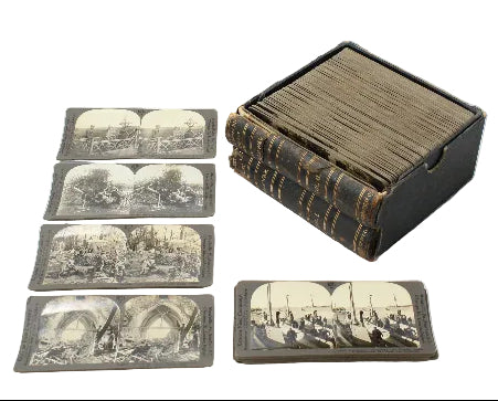 Set of vintage stereoscopic cards with a black leather case on a white background