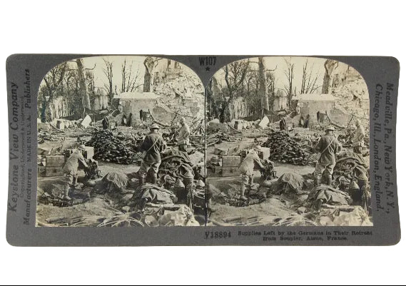 Vintage stereoscopic card showing a scene with soldiers and supplies, likely from World War I.