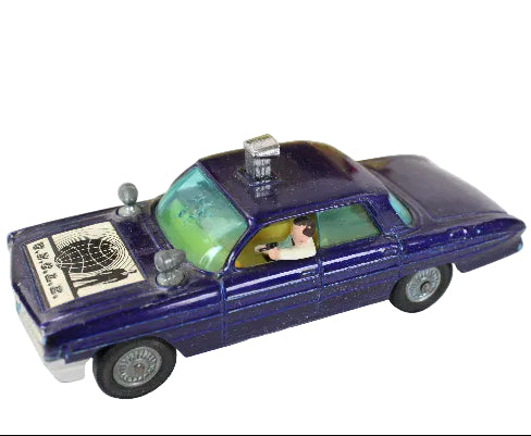 Vintage toy police car with a driver figure on a white background