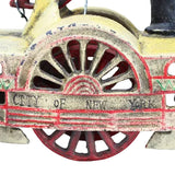 Vintage toy steamroller with 'City of New York' branding on a white background