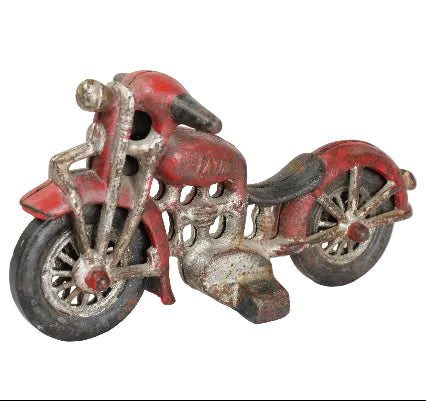 Vintage toy motorcycle with red and silver finish on a white background