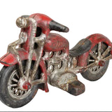 Vintage toy motorcycle with red body and silver metal parts on a white background
