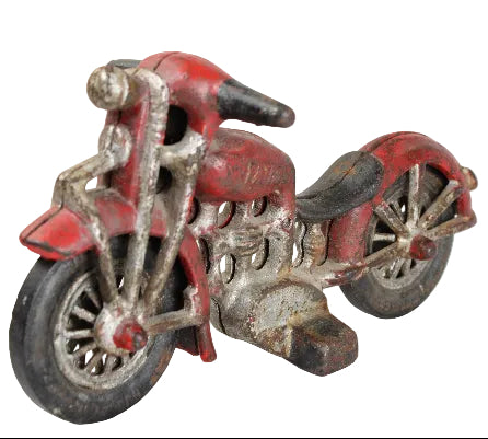 Vintage toy motorcycle with red body and silver metal parts on a white background