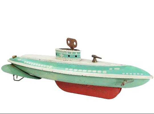 Vintage toy submarine with green body and red bottom on a white background