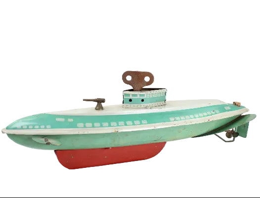 Vintage toy submarine with green body, red bottom, and white top on a white background