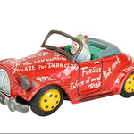 Red toy car with humorous text on a white background