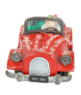 Red toy car with a character inside on a white background