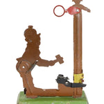 Vintage mechanical toy with a brown figure and red component on a white background