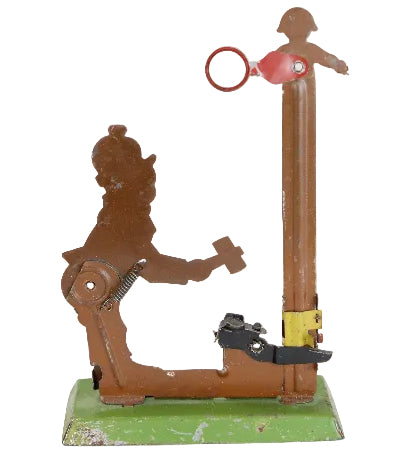 Vintage mechanical toy with a brown figure and red component on a white background