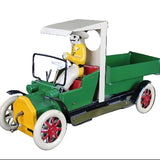 Toy model of a vintage car with a driver figure on a dark background