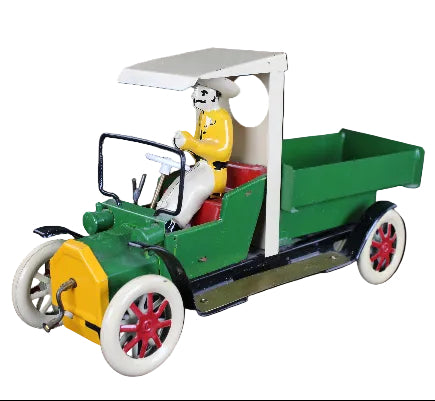 Toy model of a vintage car with a driver figure on a dark background