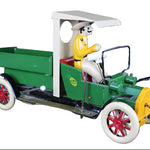 Model of a vintage green truck with a driver figure on a dark background
